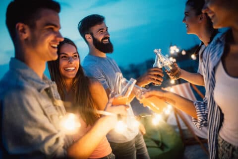 Carefree group of friends enjoying party on rooftop terrace